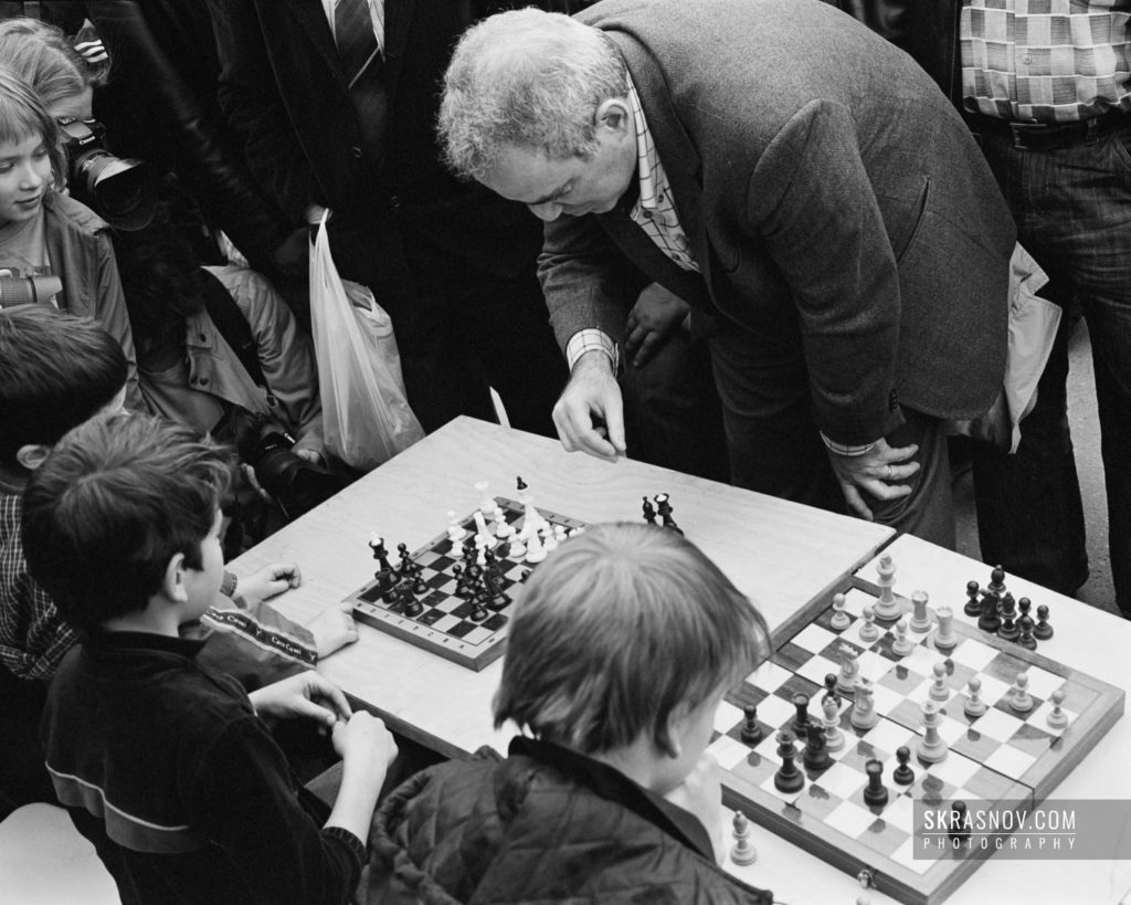 Garry Kasparov, chess grandmaster, portrait while playing with kids © Sasha Krasnov Photography
